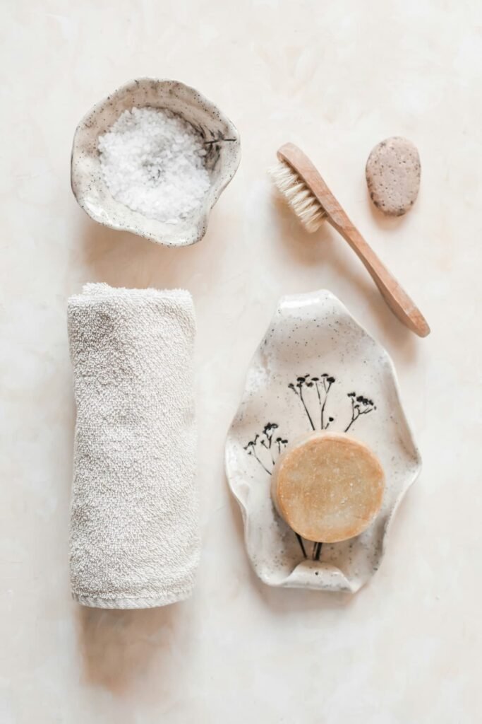 Toalla enrollada, cuencos artesanales y jabón natural, representando ritual de cuidado de la piel